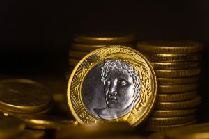 Close up on a gold and silver coin with what looks like a Roman emperor