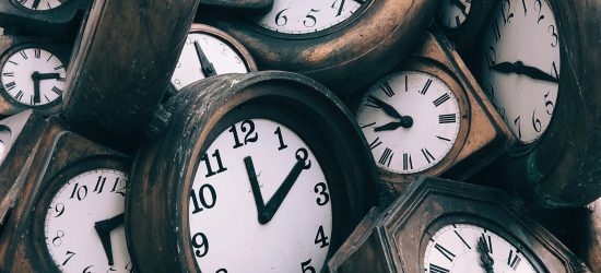 a close up of many clocks or watches in a pile
